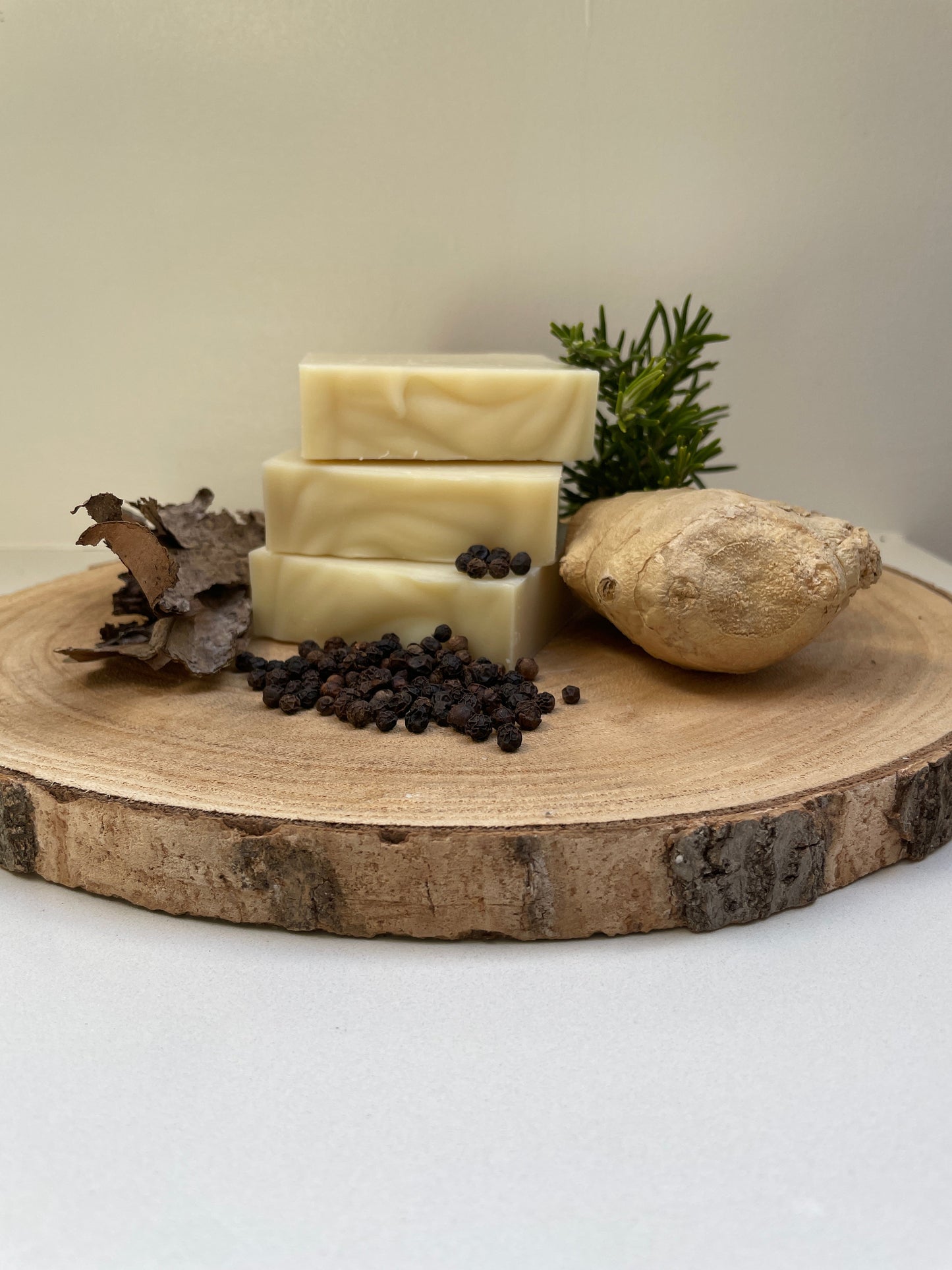 Three bars of soap on a wooden surface with a natural background