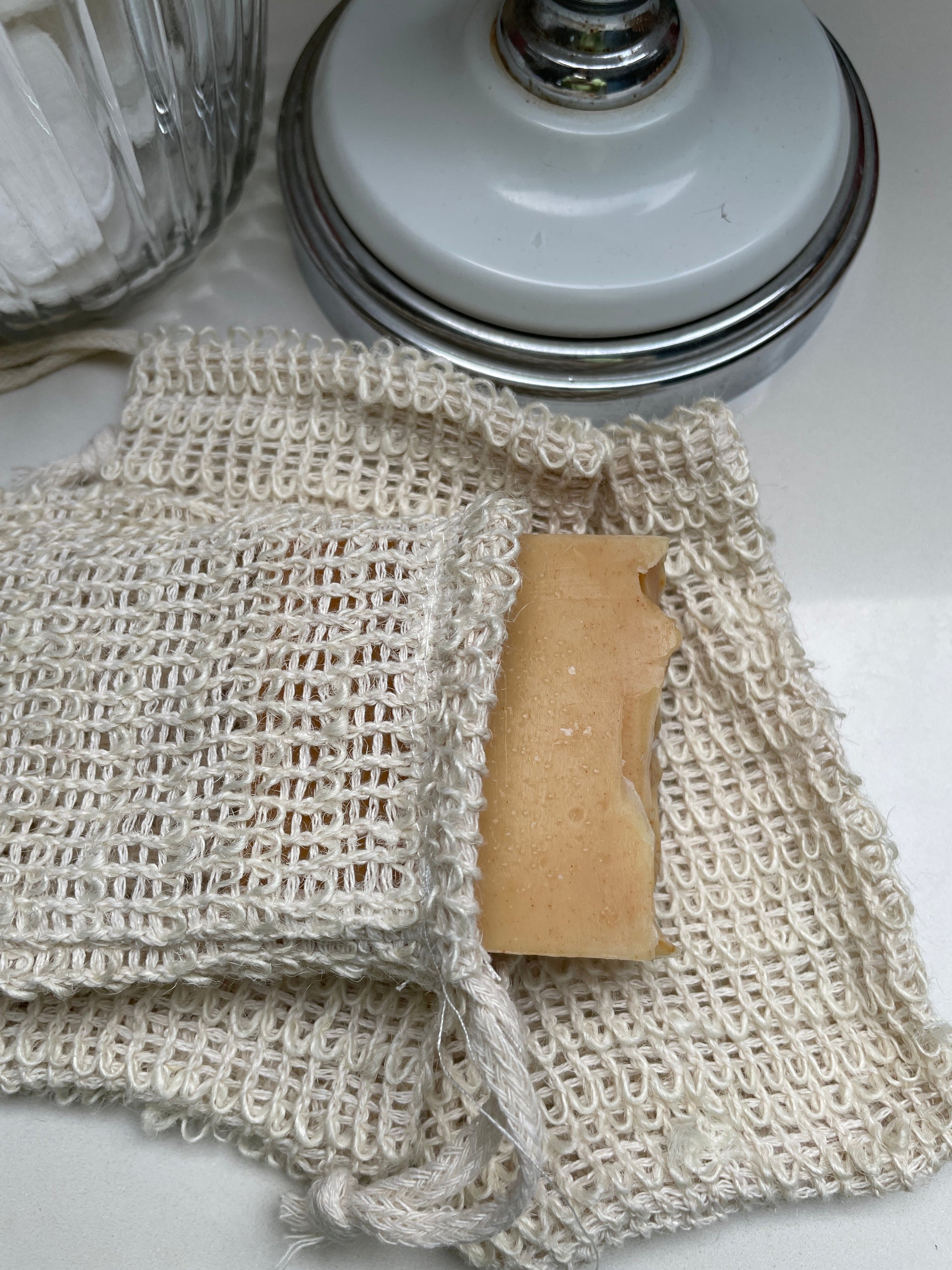 Sisal soap saver bags, one contain a bar of soap.